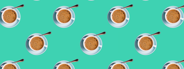 Seamless Pattern made with coffee cups on green background.