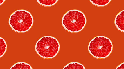 Seamless Pattern made with slices of orange fruit on bright background.