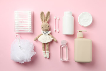 Flat lay with baby hygiene accessories on pink background