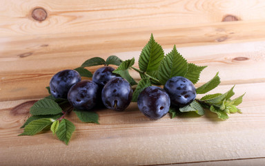 Blue plums on table