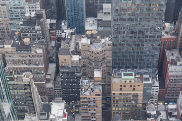 Manhattan skyscrapers seen from the Top of the rock viewpoint in the rockefeller building, hundreds of buildings seen from above, the sky has clouds