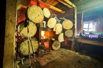 Stocks of firewood in a mountain shelter and stove