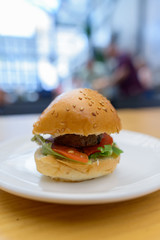Portrait of small hamburger in bite size on plate