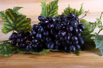 Grape and leaves on table