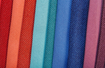 colorfull textile lies on a colorfull palette of the artist.Colored brushes and fabrics.