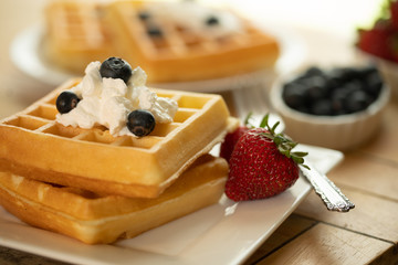 Belgian waffles on plate with fruit