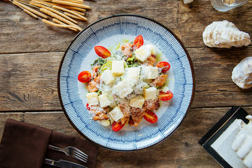 Gourmet appetizing caesar salad with fried chicken