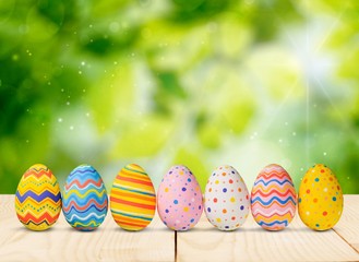 Easter eggs painted in different colors on the desk