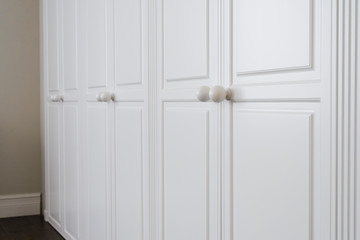 White cabinet doors with brown floor handles