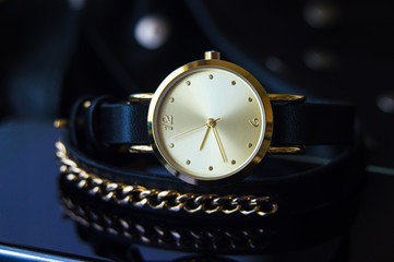 Watch with a leather strap and chain round dial in black and blue colors with space for text background