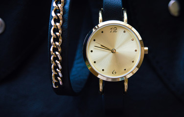 Watch with a leather strap and chain round dial in black and blue colors with space for text background