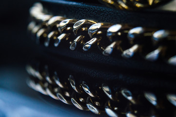 Watch with leather strap and chains details in black and blue tones place for text background texture