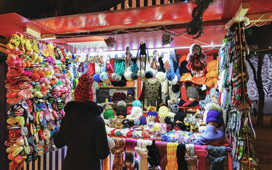 Colorful woolen clothes and consumer at Riga Street Christmas Market