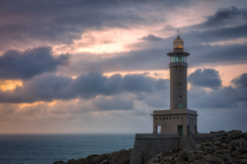 Punta Nariga Lighthouse at sunset in Malpica, Galicia, Spain