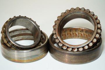 Old bearings for industrial machinery on a white background