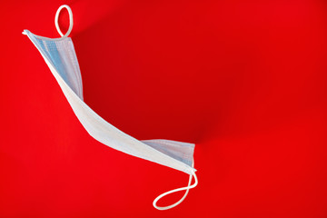 Mask to prevent covid-19 virus infection, hygiene mask, mask on red background. Healthcare and...