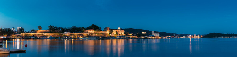 Fototapeta na wymiar Oslo, Norway. Akershus Fortress In Summer Evening. Night View Of Famous And Popular Place. Panorama, Panoramic view