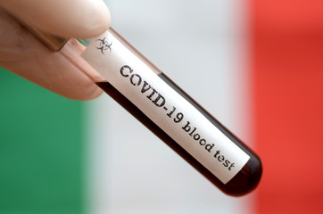 Obraz premium Stock photo of holding tube with Blood Test(novel Coronavirus 2019 disease,COVID-19,nCoV) and flag of Germany. Germany virus outbreak.