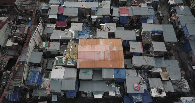 Aerial flight backtracking over slums tilting up to reveal the sea, Tondo, Manila, Philippines