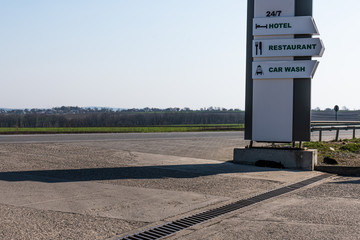 Hotel, restaurant and car wash sign near the highway