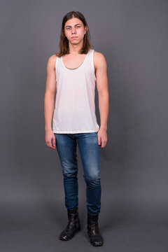 Young handsome androgynous man with long hair
