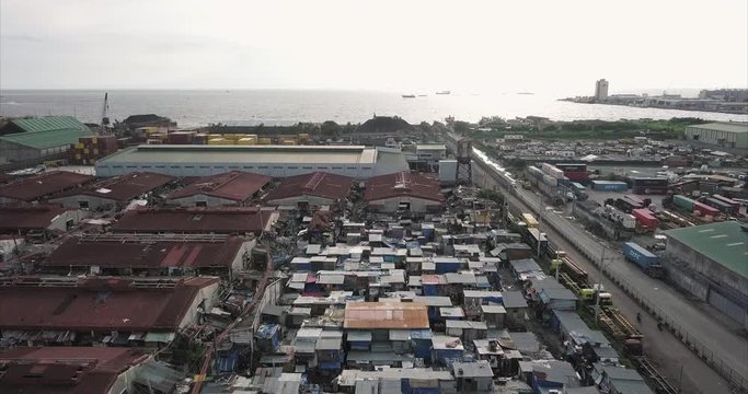 Backtracking aerial flight over squatter area then ascending, Tondo, Manila, Philippines