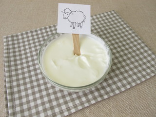 Fresh sheep quark, farmer cheese from the sheep in a glass bowl
