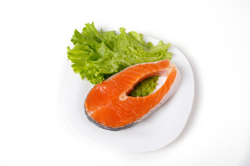 salmon steak  is isolated on a white background. The concept of cooking. Grocery background.