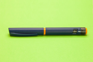 injector pen, insilin pen on a green background