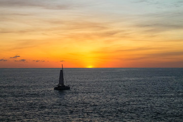 Sunset in Phuket pointview with a boat in the sea