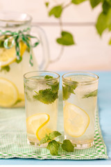 Cold lemonade with ice and mint for two on a hot summer day.