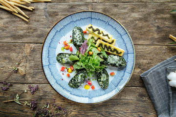 Gourmet mussels stuffed with spinach and sauce