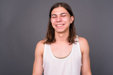 Fototapeta premium Young handsome androgynous man with long hair