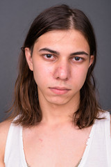 Young handsome androgynous man with long hair