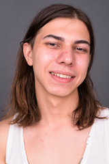Young handsome androgynous man with long hair
