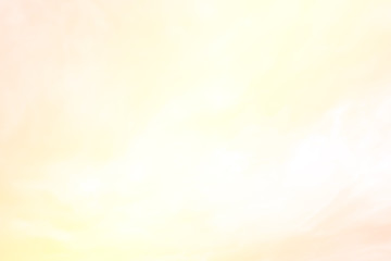 Abstract nature blurred background of gradient colorful golden pink & yellow sky with wispy smoke & clouds in tropical summer or spring morning sunlight & sun rays, exotic holiday vacation concept