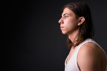 Young handsome androgynous man with long hair