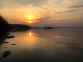 Obraz premium Beautiful red sunset over the horizon of the water in the river, sea, ocean, lake