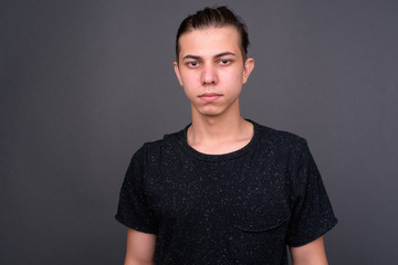 Obraz premium Portrait of young handsome man with hair tied