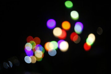 Colorful light bokeh moving on black background