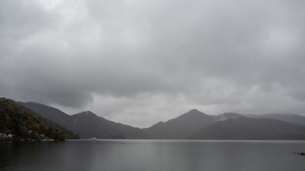 Charming scene of Chuzenji lake with mountain on cloudy sky background , Nikko , Japan