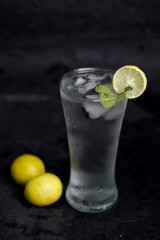 Refreshing homemade cocktail lemon juice,syrup and mint with black backgroung 