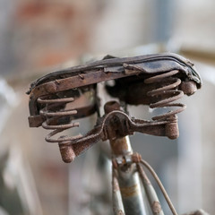 close up of an old and rusty bicycle saddle