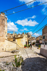 Obraz premium Sassi di Matera sunny summer street view with a male tourist in Matera, Province of Matera, Basilicata Region, Italy