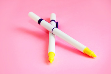 office supplies pens marker for drawing on a pink background