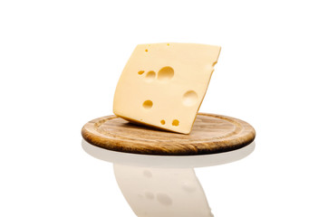 fresh cheese lies in a Board on a white background, with a reflection