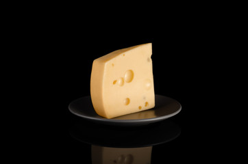 fresh cheese is on a plate on a black background
