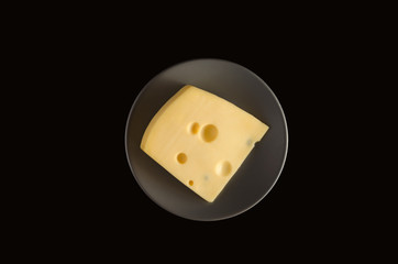 fresh cheese is on a plate on a black background