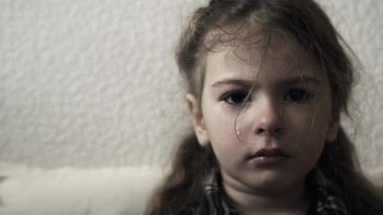 Crying child. Mistreated little girl. Child abuse concept.