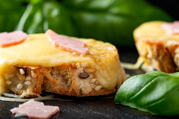 Warm bruschetta with ham and melted cheese